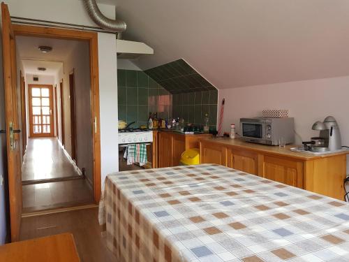 a kitchen with a bed in a room at Eszter Panzió in Praid