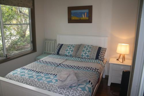 A bed or beds in a room at The Beach Hut Avoca Beach NSW