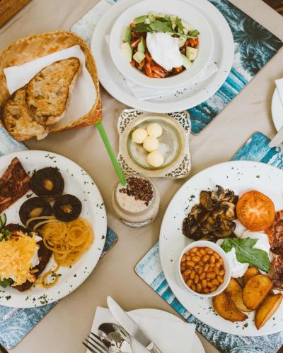 a table full of plates of food on a table at Aloe Again in Jeffreys Bay