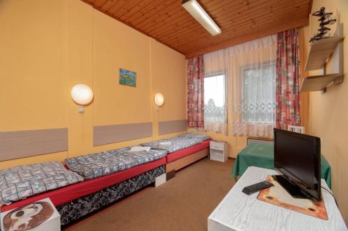 a room with two beds and a tv in it at Ubytovna Z-SPORT in Nové Město nad Metují