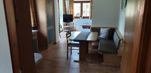 a living room with a table and a couch at Pension Lischenhof in Ehrwald
