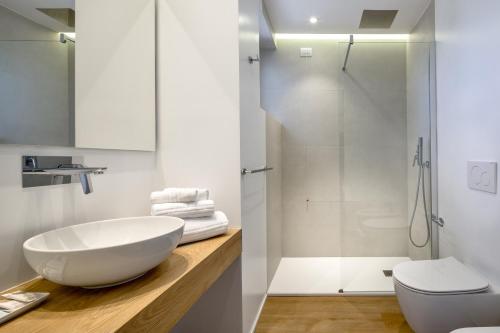 a bathroom with a white sink and a shower at Hotel Onda Marina in San Teodoro