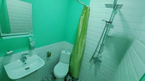 a bathroom with a toilet and a sink at ICity Hills in Kutaisi