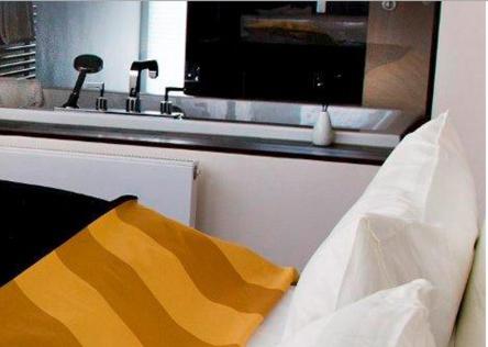 a kitchen with a sink and a yellow and white pillow at Schlosshotel Bergzaberner Hof in Bad Bergzabern