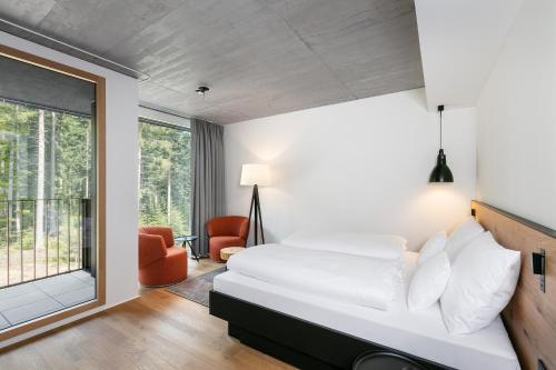 a bedroom with a bed and a large window at Fritz Lauterbad in Freudenstadt