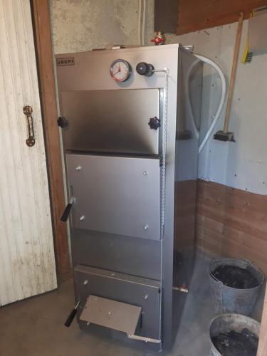 an old refrigerator with a clock on top of it at Коттедж в Финляндии (Тохмаярви) in Tohmajärvi