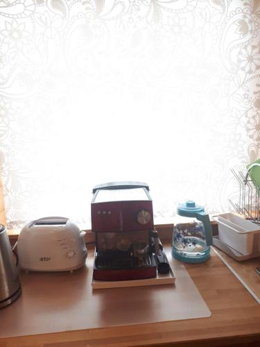 a kitchen counter with a toaster and a toaster and a printer at Коттедж в Финляндии (Тохмаярви) in Tohmajärvi