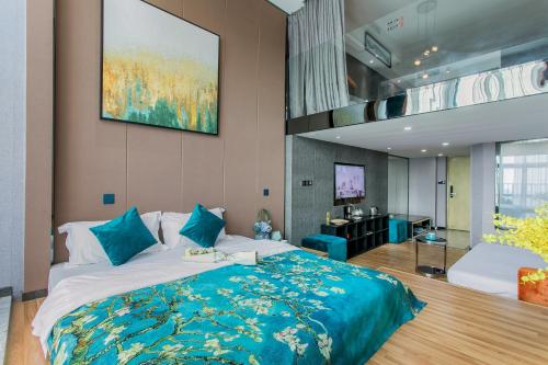 a bedroom with a large bed and a television at Lavender Apartment Branch in Guangzhou