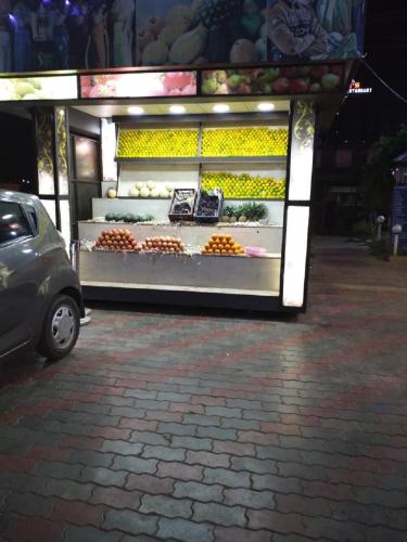 a fruit stand in a parking lot at night at saravanaa residency in Madurai