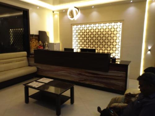a living room with a couch and a table at saravanaa residency in Madurai