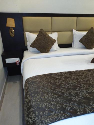 a large bed in a hotel room with a large bed at saravanaa residency in Madurai