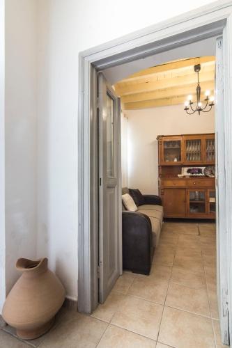 an open door to a living room with a couch and a vase at Nisyros Views in Mandrakion