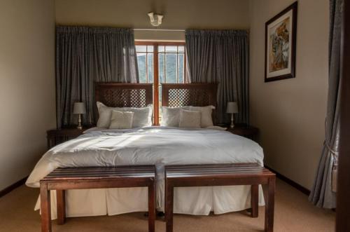 Ένα ή περισσότερα κρεβάτια σε δωμάτιο στο Rooiberg Lodge