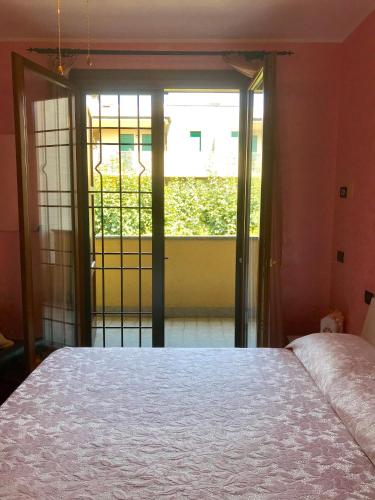 a bedroom with a bed and a large window at B&B IL VIALETTO in Orio al Serio