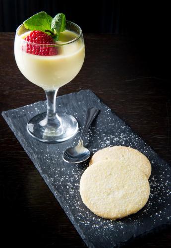 a drink and a cookie with a strawberry on a table at Eskdale Hotel in Langholm