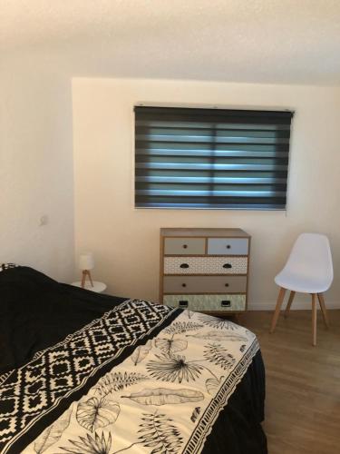 ein Schlafzimmer mit einem Bett, einer Kommode und einem Fenster in der Unterkunft duplex vue mer exceptionnelle in Porticcio