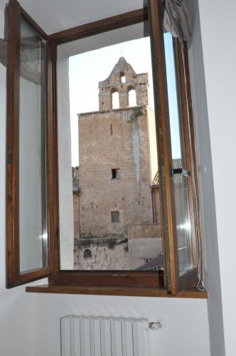 an old building seen through a window at Appartamento Mia in Orvieto