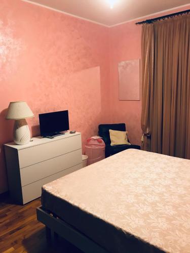 a bedroom with a bed and a desk with a laptop at B&B IL VIALETTO in Orio al Serio