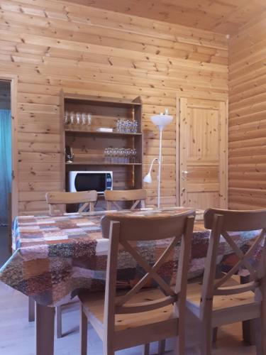 a dining room with a table and chairs at Коттедж в Финляндии (Тохмаярви) in Tohmajärvi