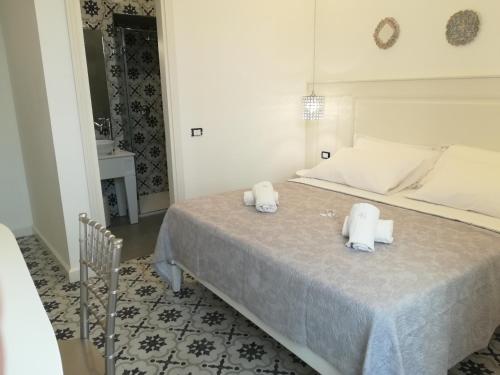 a bedroom with a bed with two towels on it at BellaVita accomodation in Tropea