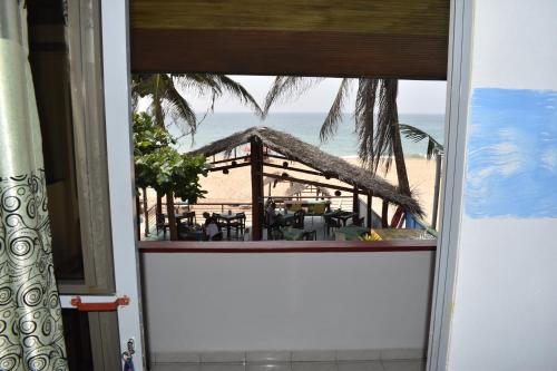 a view from a window of a beach restaurant at Whitepearl Beach in Hikkaduwa