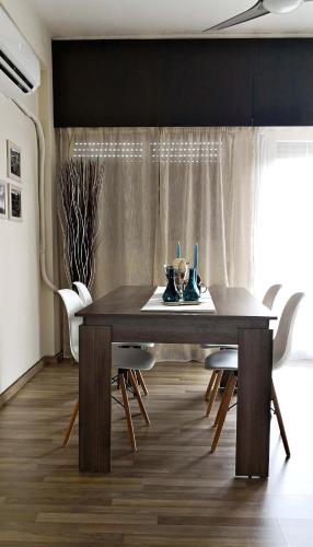 a dining room with a wooden table and chairs at The Bridge-House Apartment in Nicosia