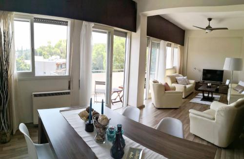 a living room with a table and chairs and a living room at The Bridge-House Apartment in Nicosia