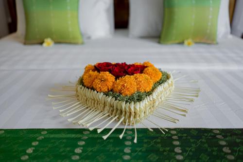 a bouquet of flowers sitting on top of a table at Cenik Villa Ubud in Ubud