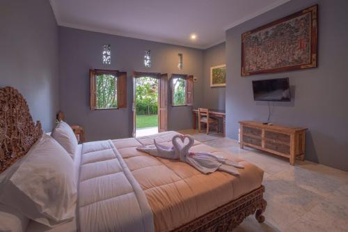 ウブドにあるPuri Cili Villa Ubudのベッドルーム1室(白鳥のベッド1台付)