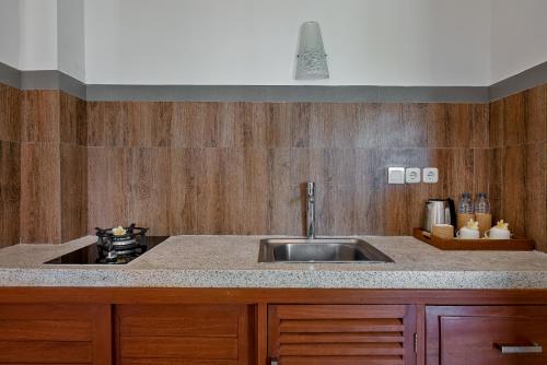 a kitchen with a sink and a counter top at Cenik Villa Ubud in Ubud