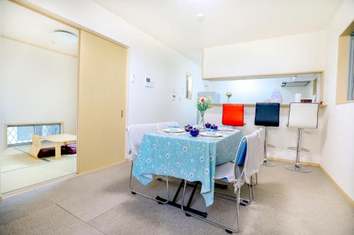 a dining room with a table and chairs at Olina's House in Osaka