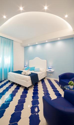 a bedroom with a bed and a blue and white floor at Marilisa Holidays in Maiori