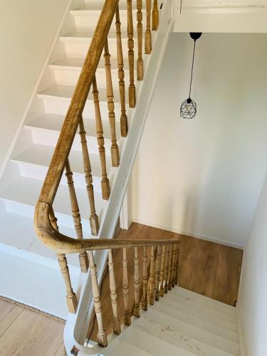 a staircase with wooden treads in a house at Zitoun in Nieuwpoort