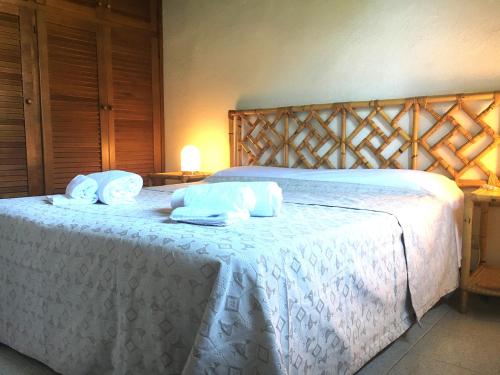 a bedroom with a white bed with towels on it at Happy Family 50 in Porto Rotondo