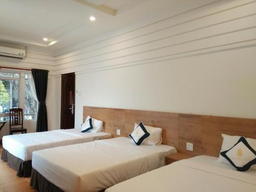 Giường trong phòng chung tại Thanh Truc Hotel Ca Mau