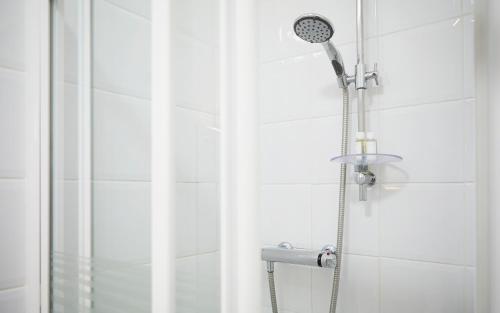 a shower with a shower head in a bathroom at Riviera Town House in Scarborough