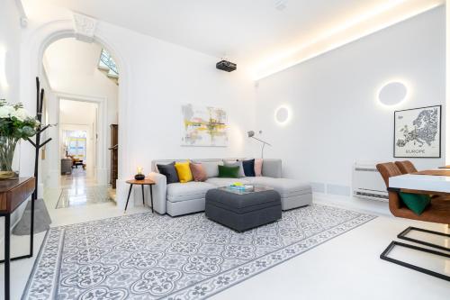 a living room with a couch and a table at Amazing Art Deco Villa 150m to sea with Daily Housekeeping in Sliema