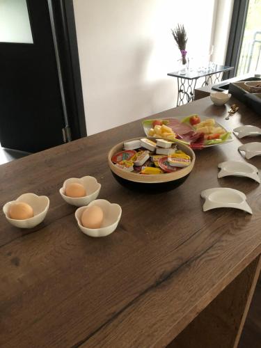un tavolo con sopra uova e ciotole di cibo di B&B Villa Dolina Plitvice a Laghi di Plitvice