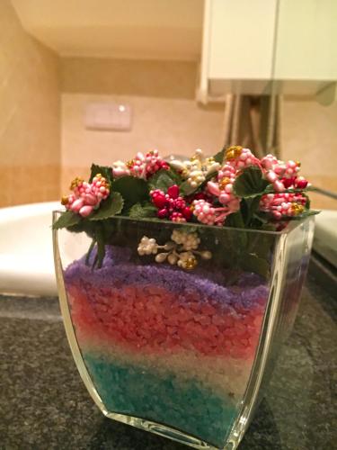 a glass vase filled with colorful liquid on a counter at KATOQI - Casa turistica nel Parco del Pollino - Basilicata in San Paolo Albanese