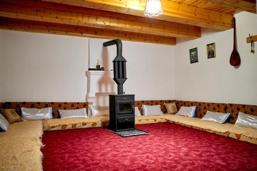 a living room with a couch and a fireplace at Guesthouse Shtini in Fshat