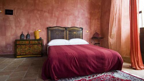 A bed or beds in a room at Locanda degli Sfizi