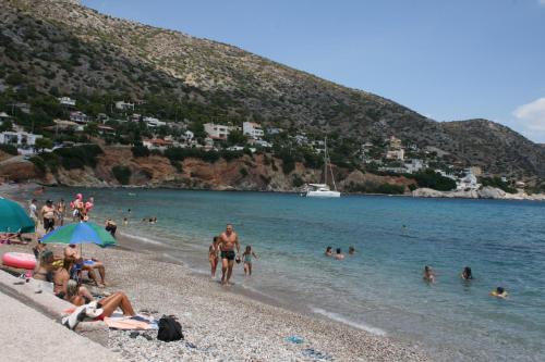 a group of people on a beach in the water at Theatraki in Selínia