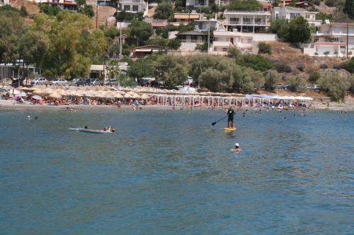 a group of people in the water at a beach at Theatraki in Selínia