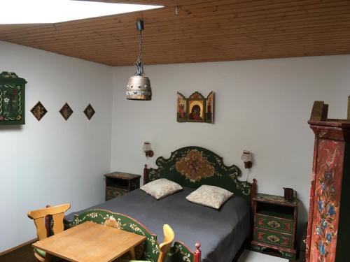 a bedroom with a bed and a wooden table at Ferienwohnung Ewa in Grassau