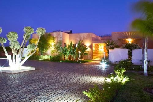 a house with a courtyard with trees and lights at Villa Jardins D'Isa in Marrakech