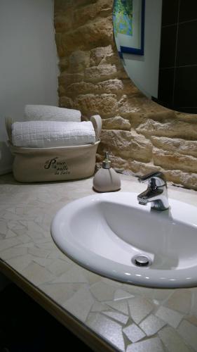 a bathroom with a white sink and a mirror at domaine du vernay in Mazille