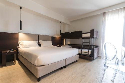a bedroom with a large bed and a loft bed at Sport Village Hotel & Spa in Castel di Sangro