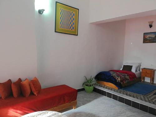 a living room with two beds in a room at Appart, Hotel & Café Agadir in Essaouira