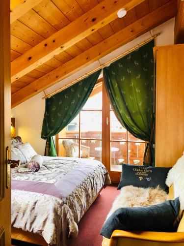 a bedroom with a bed and a large window at Golden GaPa Penthouse 1 in Garmisch-Partenkirchen