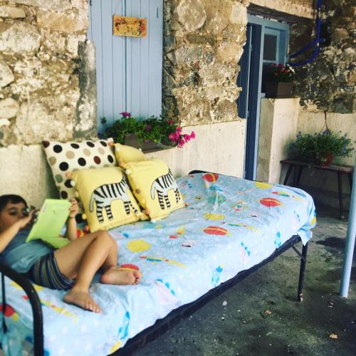 a man laying on a bed with a book at Holiday House Prodromos in Prodromos